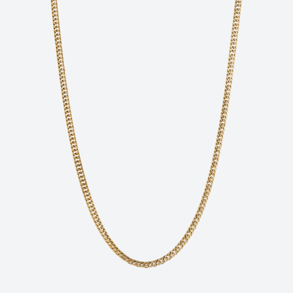 A gold-tone chain necklace with a classic curb link design, shown against a plain light gray background.