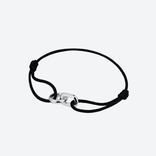 A black cord bracelet with a polished silver-toned interlocking link clasp, shown on a light gray background.