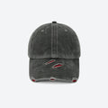 A dark gray washed baseball cap with distressed details on the brim, featuring red and white embroidery inside the tear-like rips, shown against a plain light gray background.