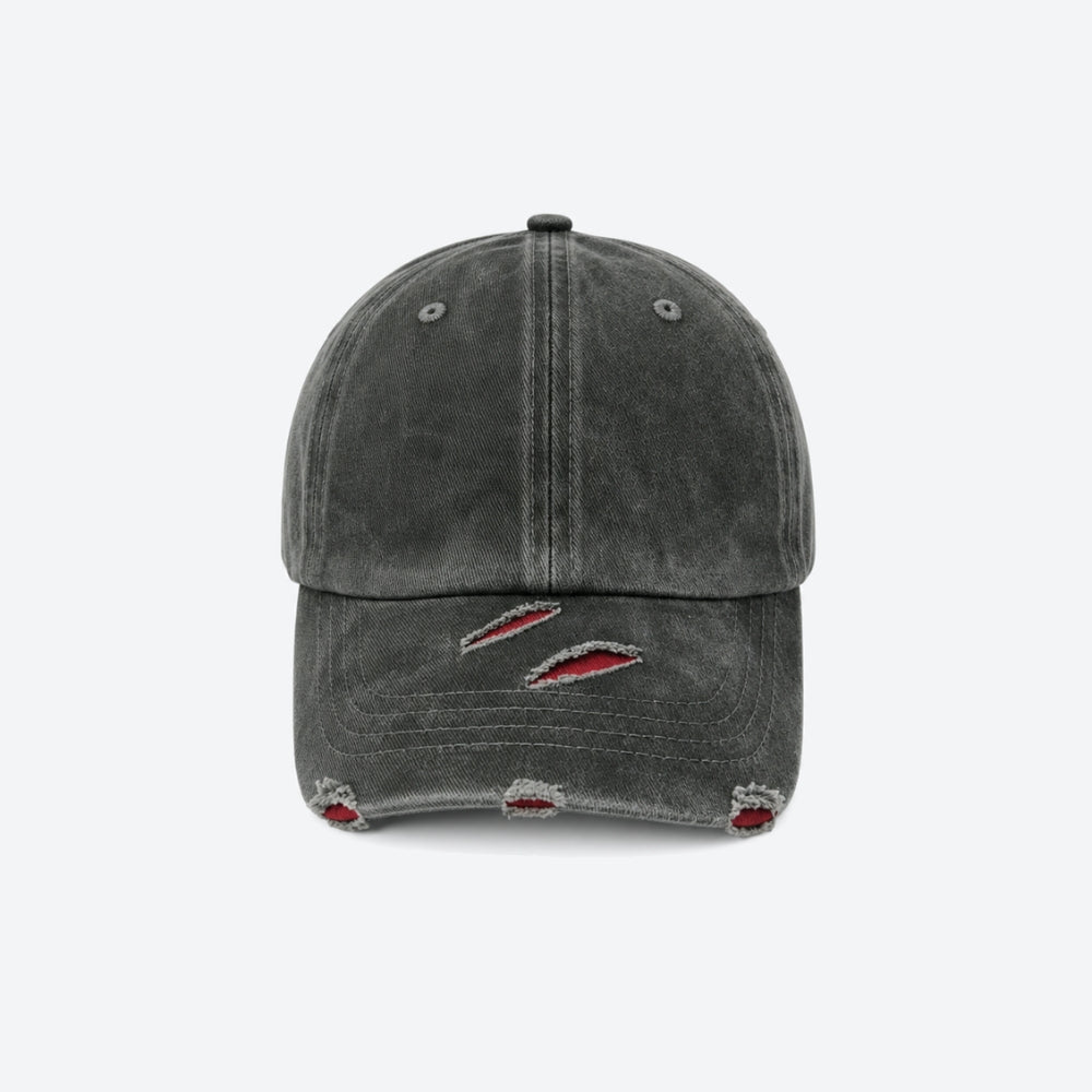 A dark gray washed baseball cap with distressed details on the brim, featuring red and white embroidery inside the tear-like rips, shown against a plain light gray background.