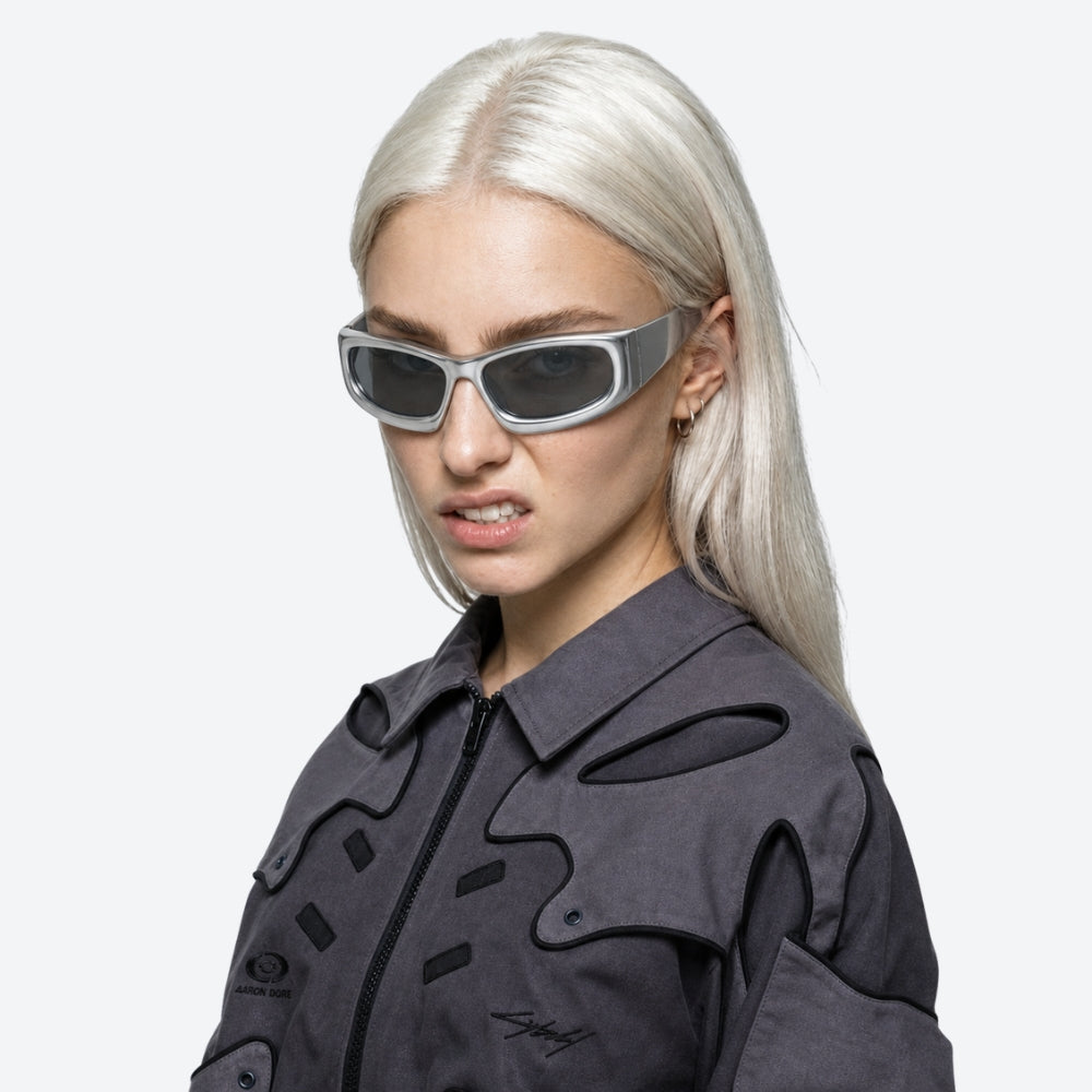 Person wearing futuristic VYSER White sunglasses with gray lenses on a white background