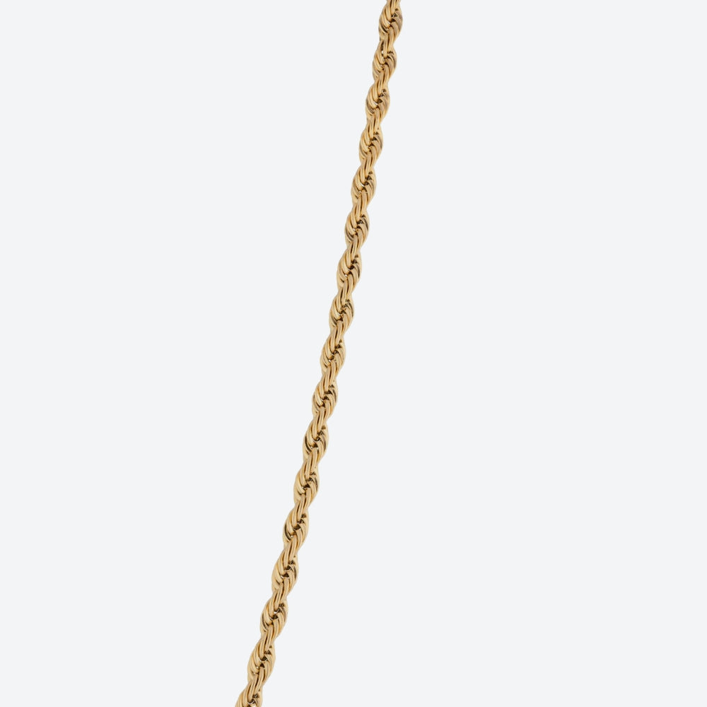 A close-up of a twisted gold chain running vertically down the center of a light gray background.