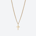 A delicate gold chain necklace with a small, minimalist cross pendant, displayed against a clean, light gray background.
