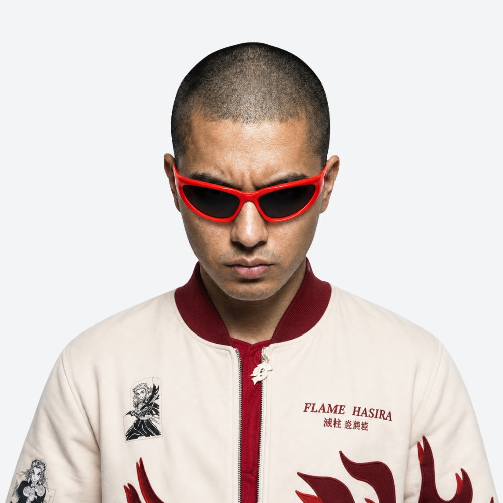Person wearing VYSER Red sunglasses with dark lenses on a white background