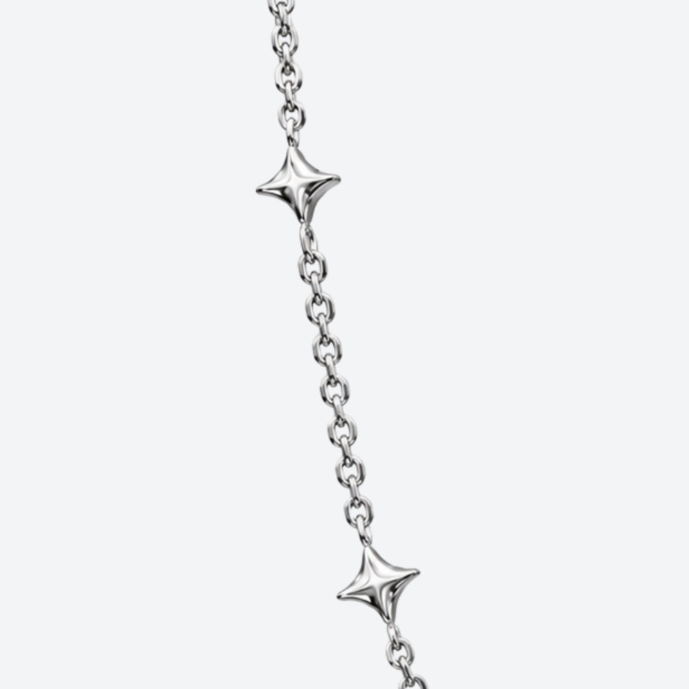 A close-up of a silver chain bracelet featuring two star-shaped starfish charms spaced along the chain, set against a solid light gray background.