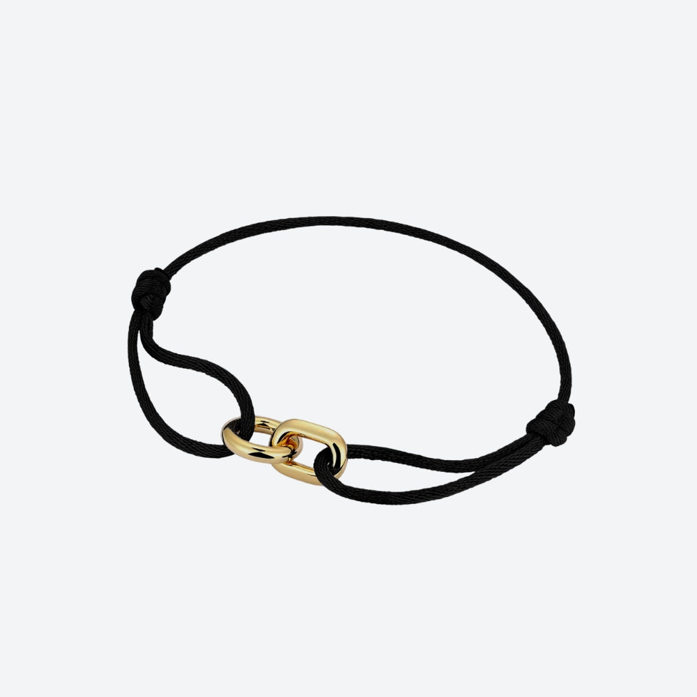 A black cord bracelet featuring a polished gold chain link clasp and adjustable sliding knot ends, shown on a light gray background.