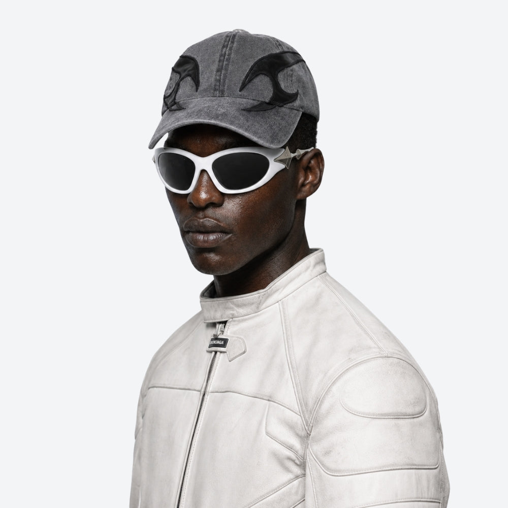 Person wearing a gray cap and VYSER WHITE sunglasses with silver STAR accents on a white background