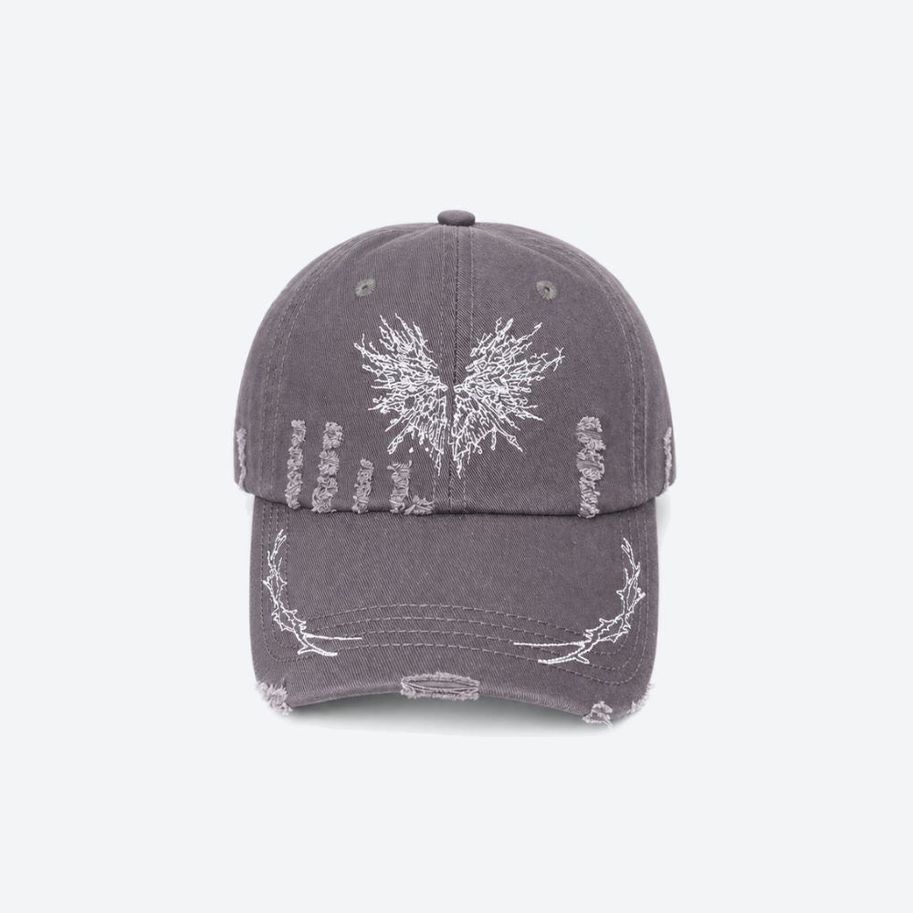 A grey distressed baseball cap with a white embroidered moth on the front and thorn branch detailing along the brim, shown from the front
