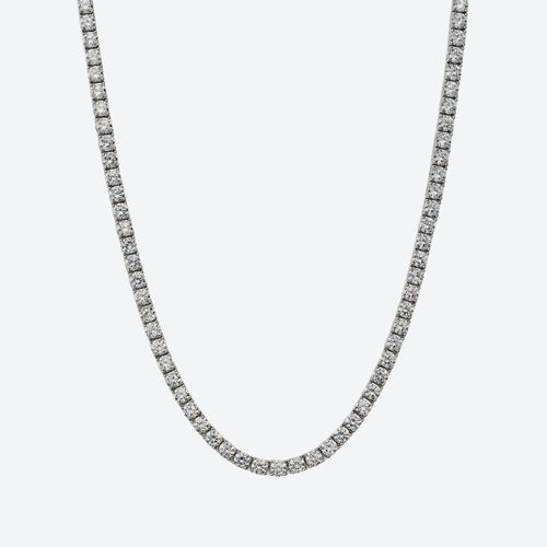 A silver-toned tennis chain necklace paved with small clear stones, shown against a plain light gray background.