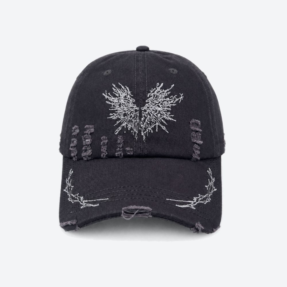 A black distressed baseball cap with a white embroidered moth on the front and thorn branch detailing along the brim, shown from the front