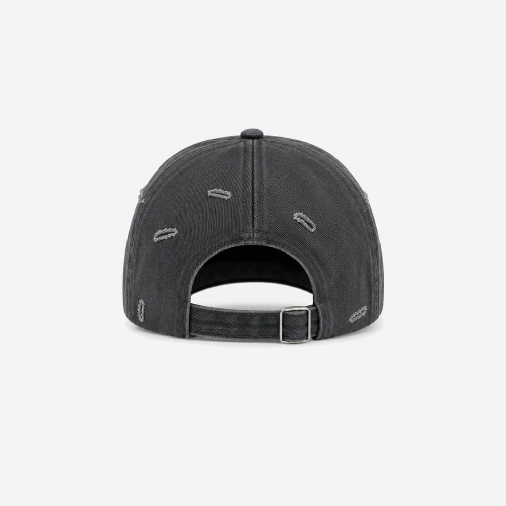 A dark gray washed baseball cap shown from the back, featuring distressed details and an adjustable strap with a silver buckle, on a light gray background.