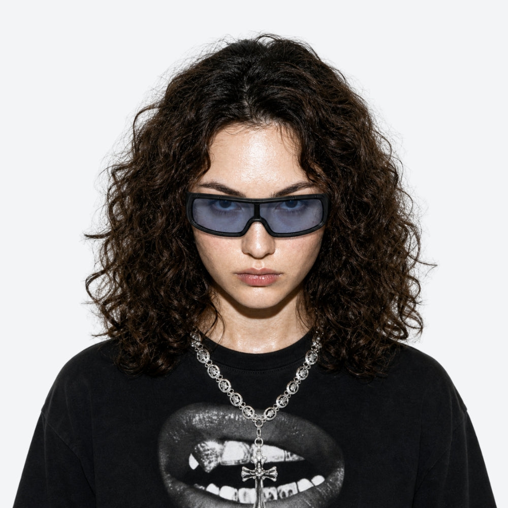 Person wearing VYSER Black sunglasses with dark lenses on a white background