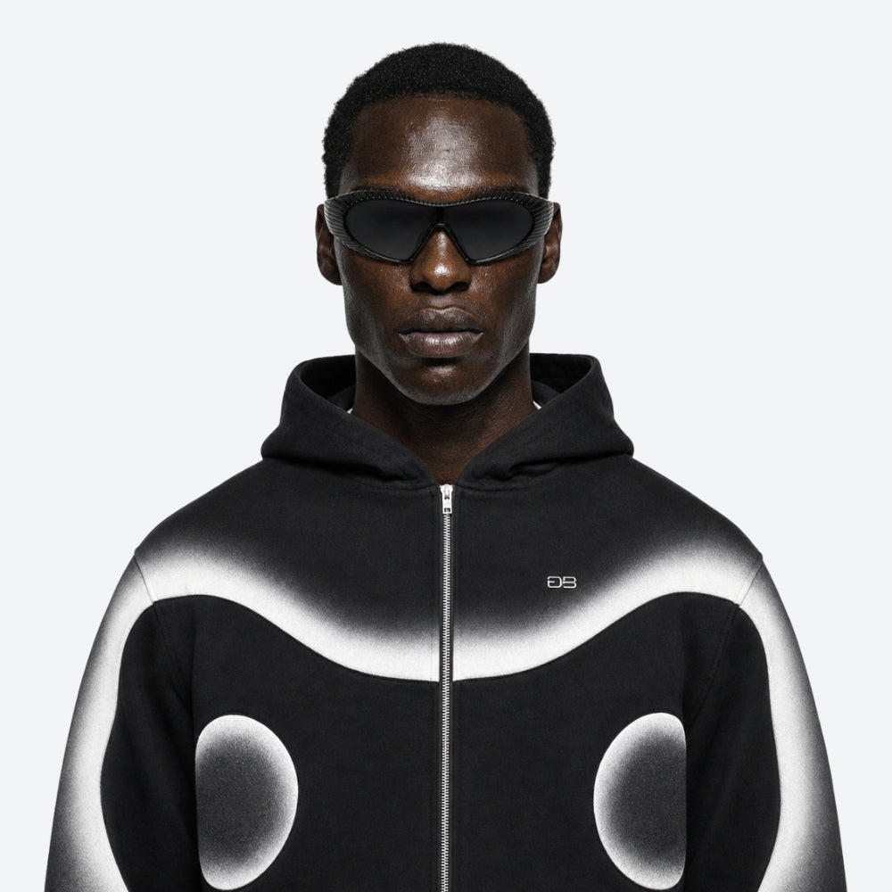 Person wearing a black and white hoodie with VYSER Black sunglasses with a ribbed frame on a white background