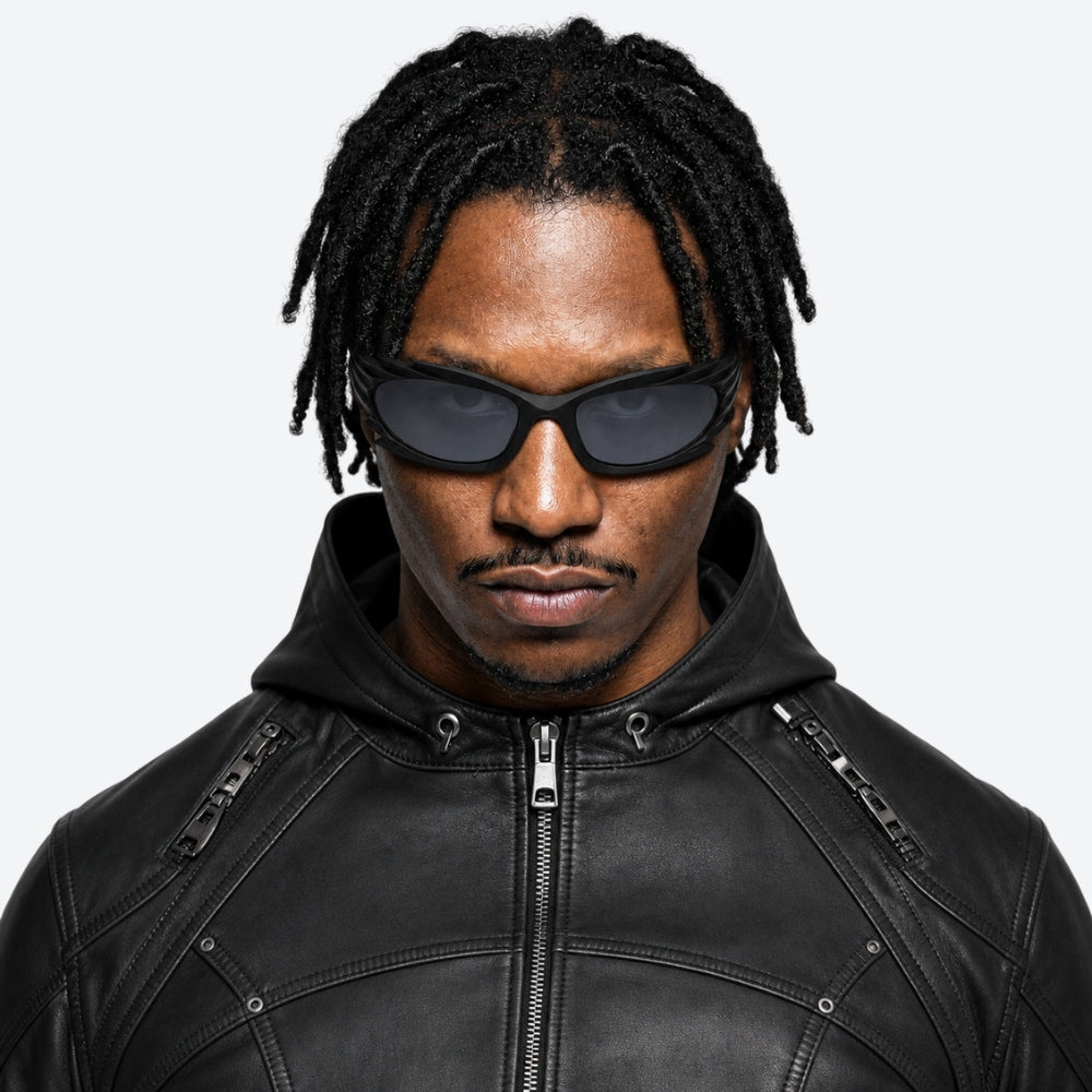 Man wearing a black leather jacket and VYSER Black sunglasses with unique frame design on a white background