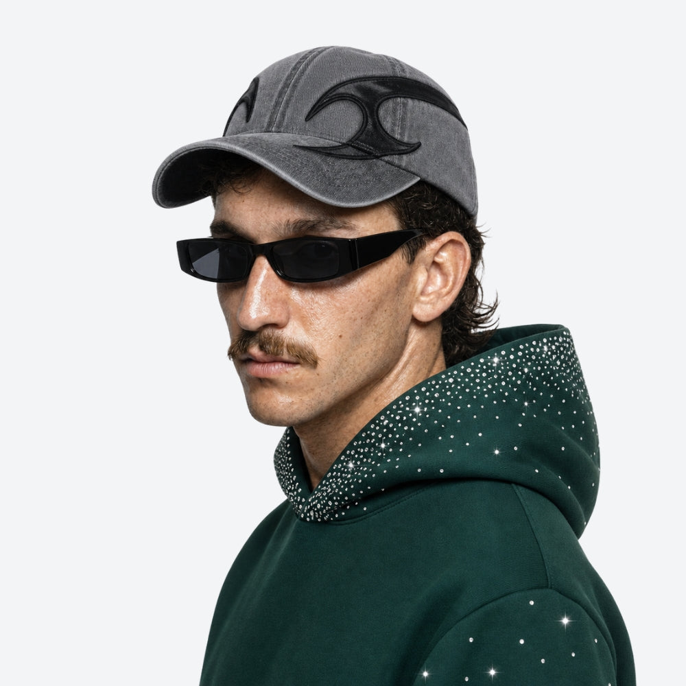 Man wearing a gray cap and dark VYSER Black sunglasses on a white background