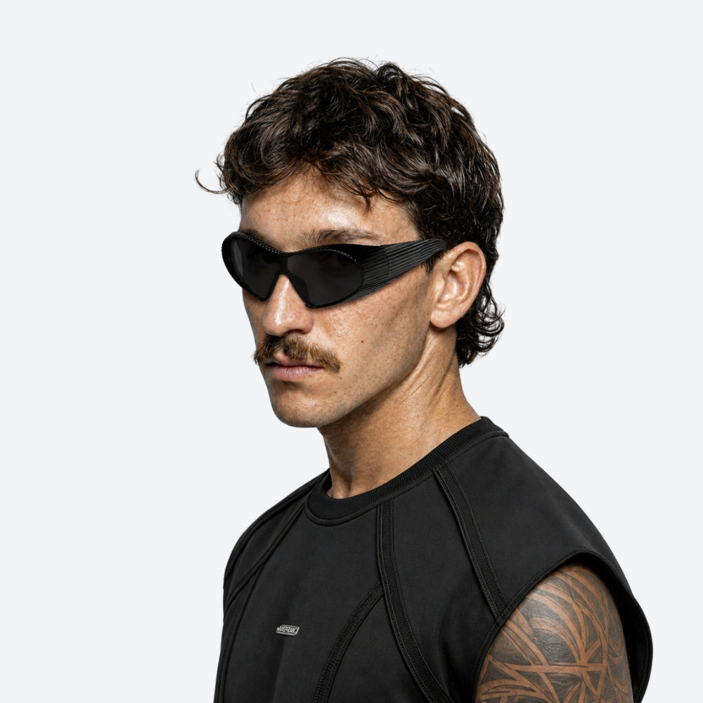 Man wearing VYSER Black sunglasses with a ribbed frame on a white background