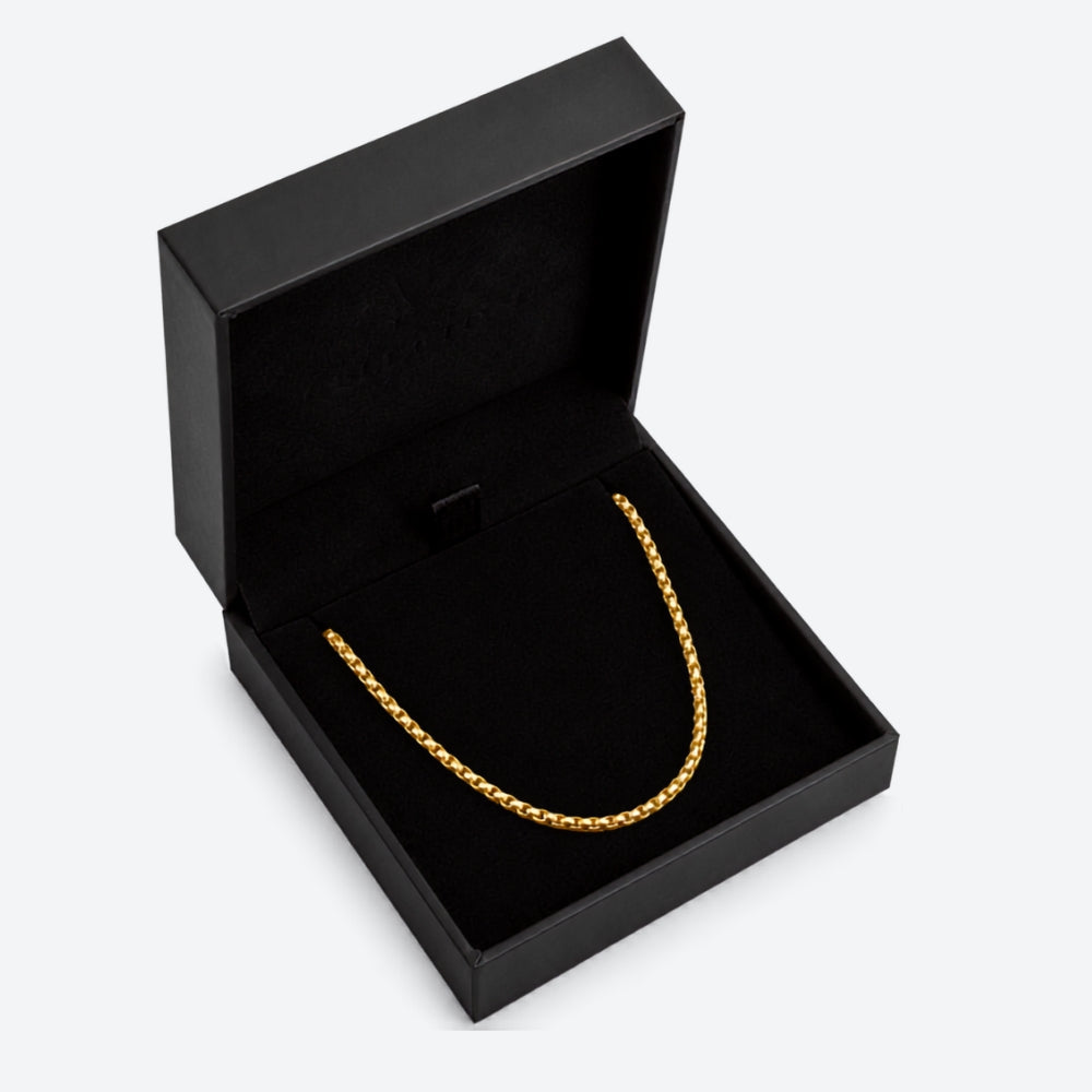 GOLD. A gold box chain necklace displayed inside an open black jewelry box, on a light gray background.