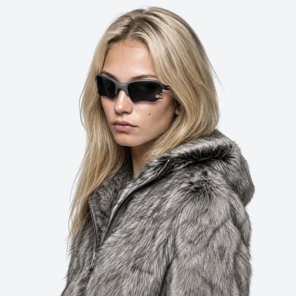 Person wearing a textured hoodie and VYSER Black sunglasses with dark lenses on a white background