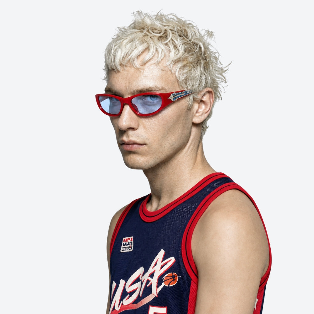Person wearing a sports jersey and VYSER Red sunglasses with a decorative arm on a white background
