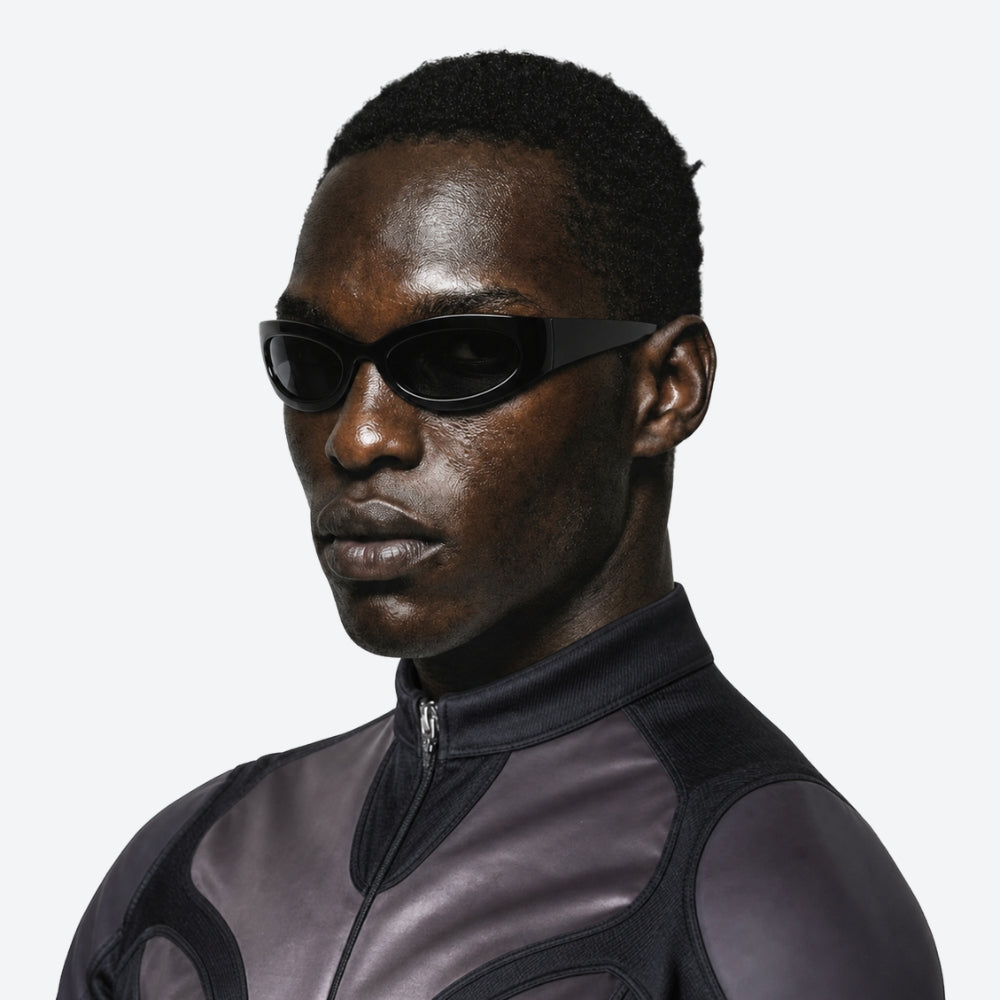 Person wearing a dark suit with VYSER Black sunglasses on a white background