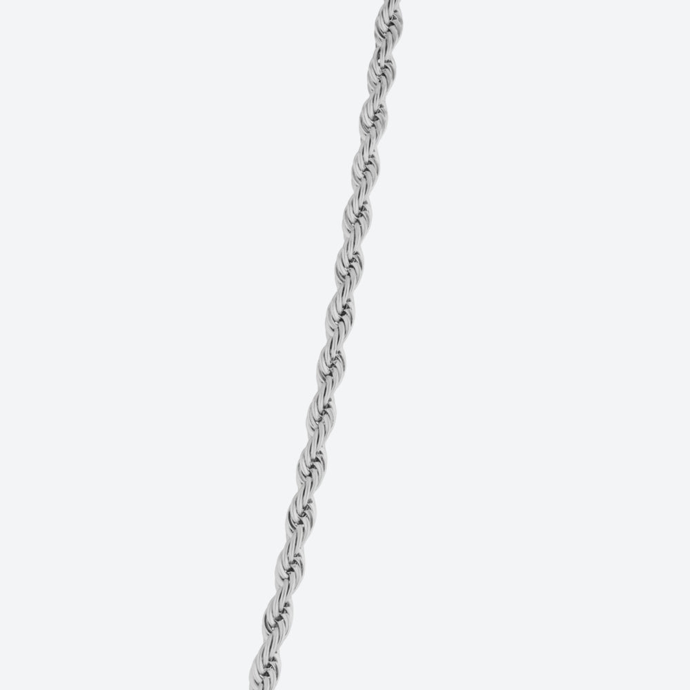 A close-up of a silver twisted rope chain running vertically against a light gray background.
