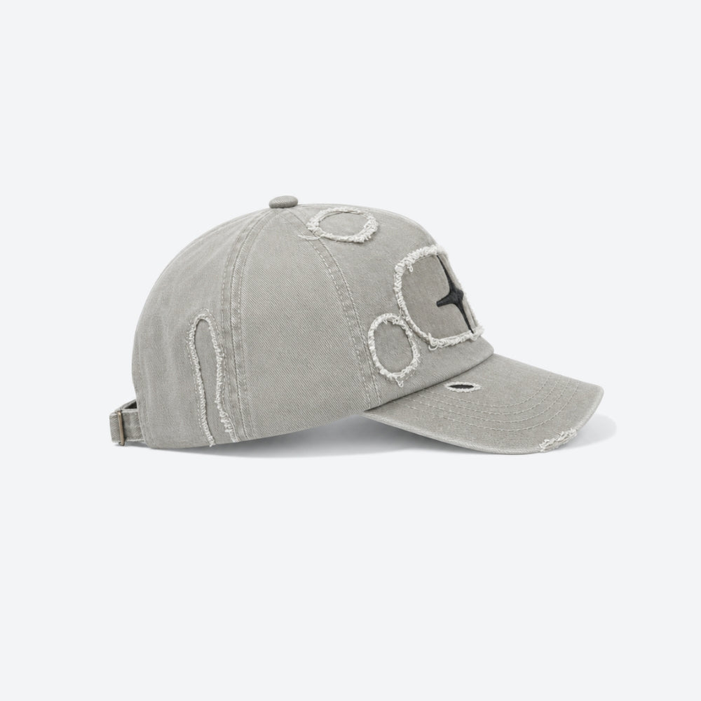 A light gray distressed baseball cap with raw-edge embroidery and a black embroidered star on the side, shown against a plain white background.