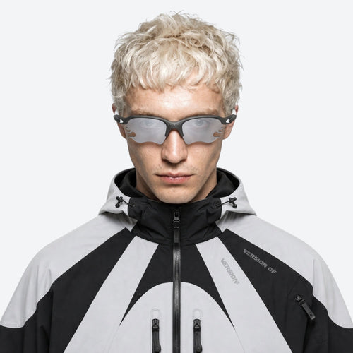 Person wearing a black and VYSER White sunglasses with dark lenses on a white background
