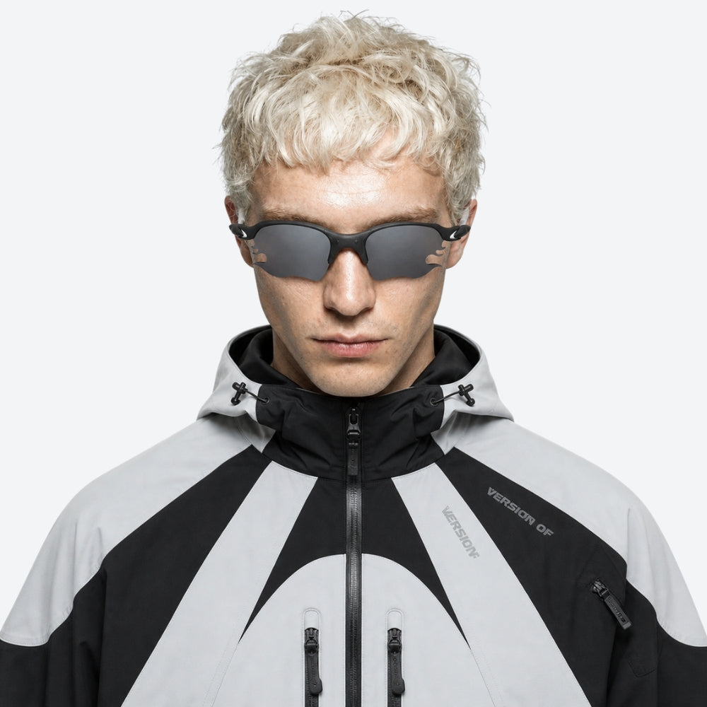 Person wearing a black and VYSER White sunglasses with dark lenses on a white background