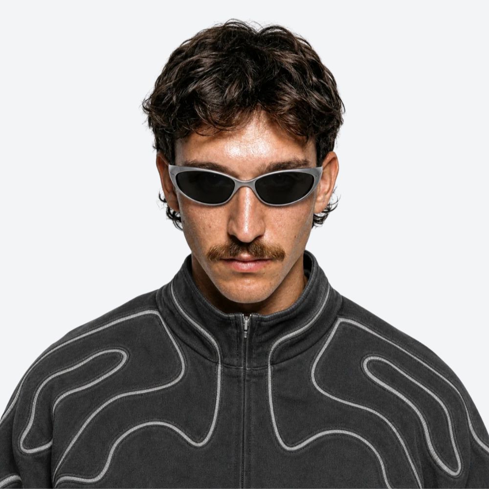 Man wearing VYSER Silver sunglasses with dark lenses on a white background