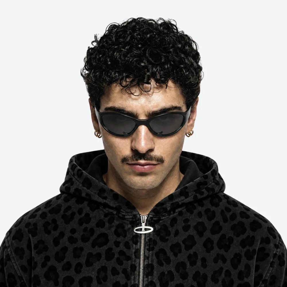 VYSER black cat-eye sunglasses with sleek frame, styled with black leopard-print hoodie for bold streetwear look