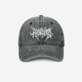 A washed grey baseball cap with a white gothic blackletter logo embroidered on the front, shown from the front