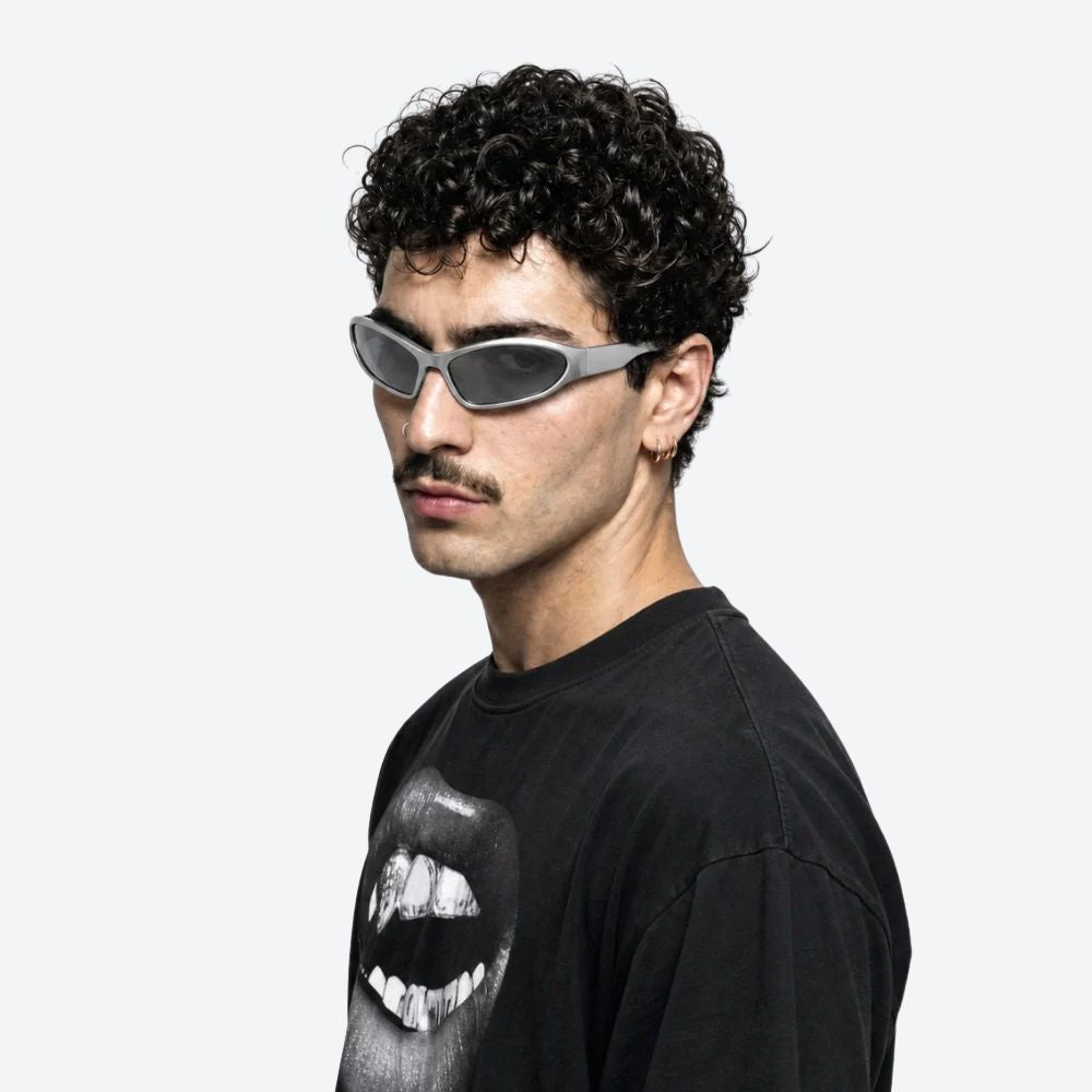 Man wearing a black t-shirt with a graphic design and VYSER White sunglasses on a white background, posing against a white background